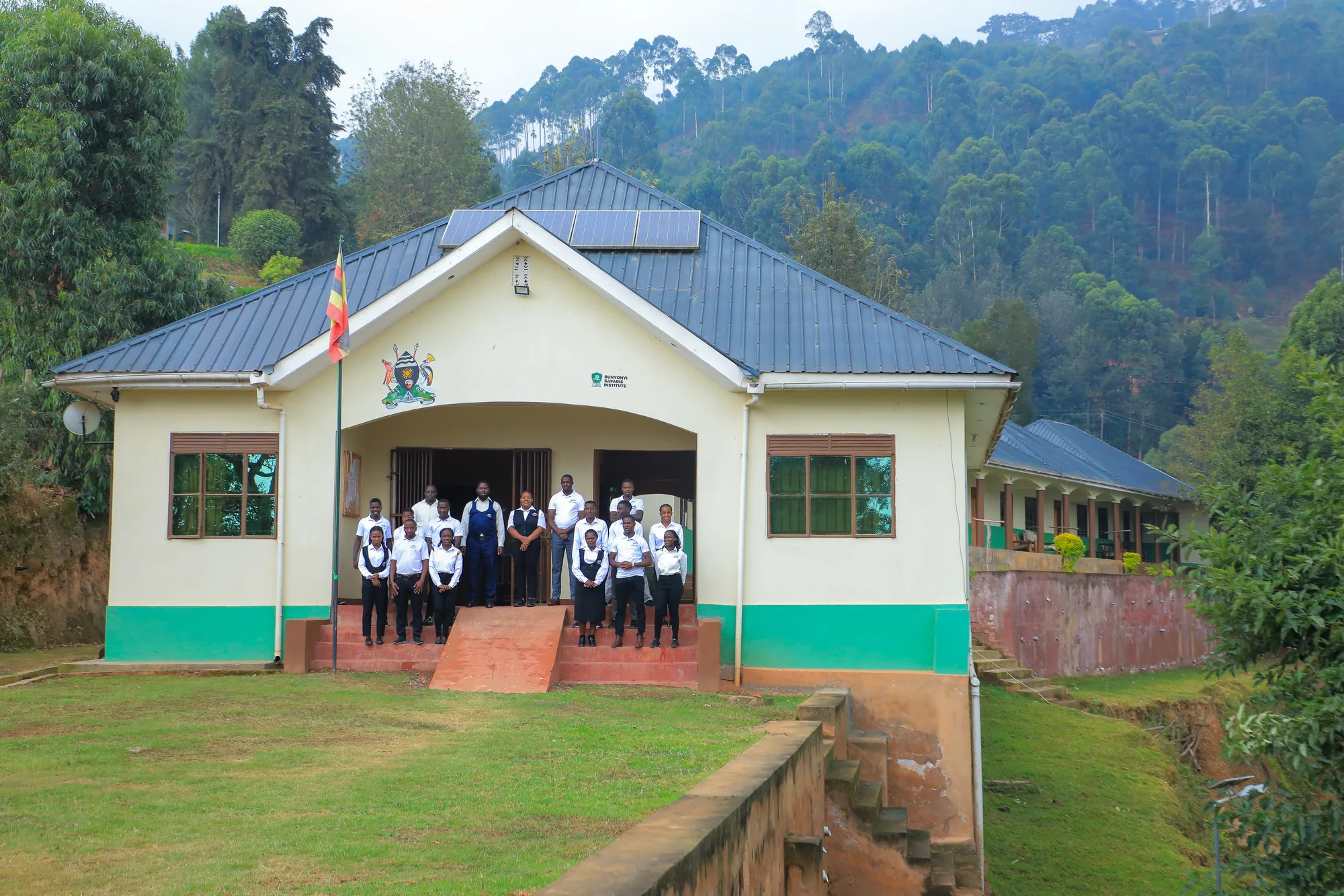 Students on the entrance steps of the institute with the classroom blocks running away behind